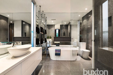 Design ideas for a contemporary bathroom in Melbourne with white cabinets and a freestanding tub.