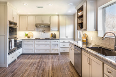 Enclosed kitchen - mid-sized transitional u-shaped ceramic tile and brown floor enclosed kitchen idea in Dallas with an undermount sink, shaker cabinets, beige cabinets, granite countertops, beige backsplash, ceramic backsplash, stainless steel appliances and multicolored countertops