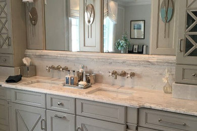 Design ideas for a large transitional master bathroom in New York with recessed-panel cabinets, grey cabinets, a freestanding tub, an alcove shower, a one-piece toilet, white tile, stone tile, white walls, marble floors, an undermount sink and marble benchtops.