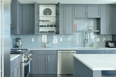 Kitchen - transitional l-shaped dark wood floor and brown floor kitchen idea in Minneapolis with an undermount sink, shaker cabinets, gray cabinets, gray backsplash, stainless steel appliances, an island and white countertops