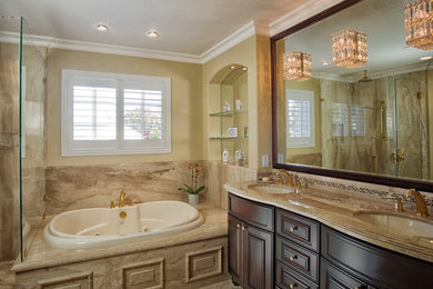 Example of a classic master beige tile and glass tile marble floor bathroom design in San Francisco with furniture-like cabinets, dark wood cabinets, marble countertops and beige walls