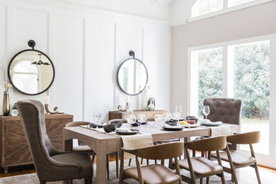 Photo of a transitional dining room in Raleigh with white walls and medium hardwood floors.