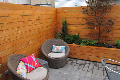 Inspiration for a large contemporary backyard patio in Philadelphia with a container garden, tile and no cover.