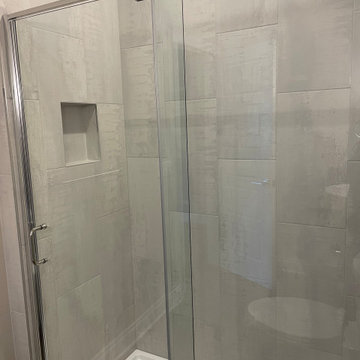 Beautiful Shower done with 12x24 porcelain tiles installed vertically.
