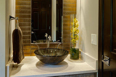 Inspiration for a small rustic 3/4 brown tile and porcelain tile alcove shower remodel in Chicago with flat-panel cabinets, distressed cabinets, beige walls, a vessel sink, quartzite countertops and a hinged shower door