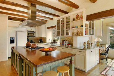 Inspiration for a mid-sized timeless u-shaped dark wood floor eat-in kitchen remodel in Albuquerque with shaker cabinets, distressed cabinets, beige backsplash, paneled appliances and an island