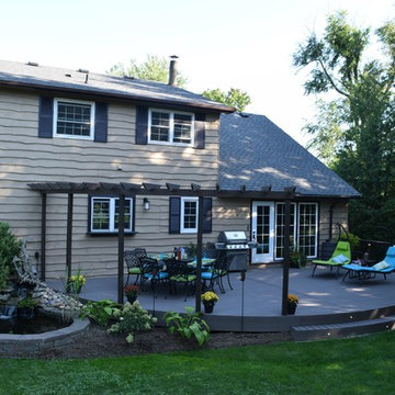 A curved Geo deck with cedar pergola.