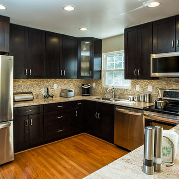Espresso Kitchen Remodel with Granite Island and Stainless Steel Appliances