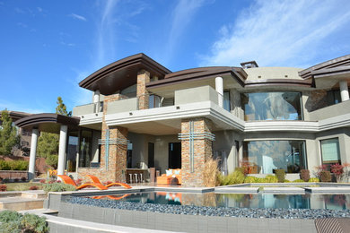 Large contemporary beige two-story mixed siding flat roof idea in Las Vegas