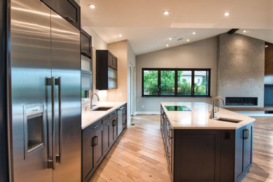 Eat-in kitchen - contemporary light wood floor eat-in kitchen idea in Other with an undermount sink, shaker cabinets, black cabinets, quartz countertops, white backsplash, mosaic tile backsplash, stainless steel appliances, an island and white countertops