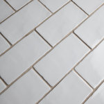 Merola Tile - Antic Craquelle Gris Claro Ceramic Wall Tile - Bring unique vintage accents to your home with our Antic Craquelle Gris Claro Ceramic Wall Tile. This high sheen tile features a crackle glaze which adds subtle appeal. The edges of this tile are not straight, giving each piece a handmade feel. The tile color is a cool light grey, which gives a monochromatic overtone to any room. This tile has a few different variations, making your installation look beautifully handmade. It is necessary to seal this tile before grouting to prevent the absorption of staining agents over time. Use this subway tile alongside many different products, including those in the Antic Craquelle series. Tile is the better choice for your space. This tile is made from natural ingredients, making it a healthy choice as it is free from allergens, VOCs, formaldehyde and PVC.