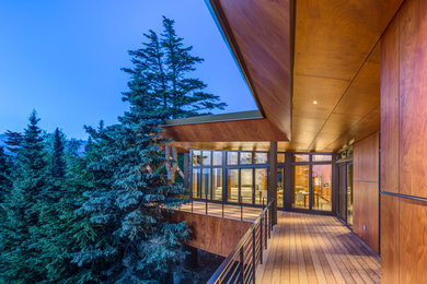 Inspiration for a rustic deck remodel in Seattle with a roof extension