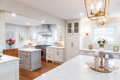 Huge french country medium tone wood floor and brown floor eat-in kitchen photo in New York with an undermount sink, shaker cabinets, white cabinets, quartz countertops, gray backsplash, ceramic backsplash, stainless steel appliances, two islands and white countertops