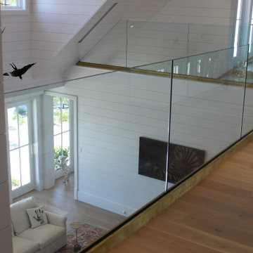 Glass Balustrade with Aluminum Base Rail Finished with Satin Brass Cladding