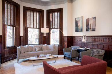 Mid-sized transitional open concept light wood floor living room photo in Boston with white walls, no tv, a standard fireplace and a wood fireplace surround