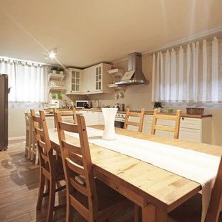 This is an example of a large rural walk-out basement in Milan with multi-coloured walls, painted wood flooring, a standard fireplace, a concrete fireplace surround and brown floors.