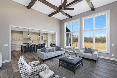 Example of a mid-sized transitional open concept medium tone wood floor and brown floor family room design in Other with gray walls, a standard fireplace and a stone fireplace