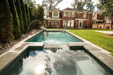 Example of a mid-sized minimalist backyard concrete and rectangular natural hot tub design in Charlotte