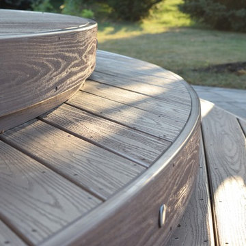 This custom Hickory Dickory Decks shows curves are in with low maintenance Veka.