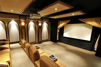 Large traditional enclosed home theatre in New York with beige walls, carpet and a projector screen.