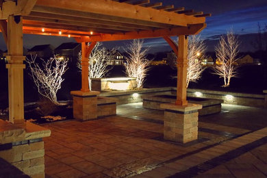 Example of a large minimalist backyard concrete paver patio design in Other with a fire pit and a pergola