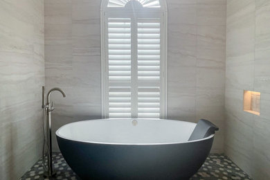 Bathroom - large contemporary master white tile and porcelain tile porcelain tile, gray floor and double-sink bathroom idea in Jacksonville with furniture-like cabinets, medium tone wood cabinets, a bidet, white walls, an undermount sink, quartz countertops, white countertops, a niche and a built-in vanity