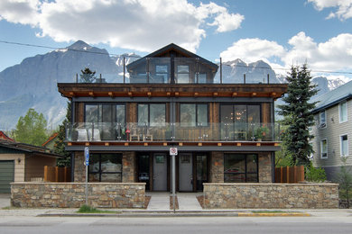 Inspiration for a large rustic multicolored two-story mixed siding exterior home remodel in Calgary