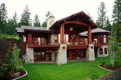 Large trendy brown two-story wood exterior home photo in Seattle