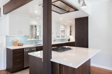Inspiration for a mid-sized mid-century modern galley vinyl floor eat-in kitchen remodel in Seattle with an undermount sink, flat-panel cabinets, dark wood cabinets, quartz countertops, blue backsplash, ceramic backsplash, stainless steel appliances, an island and white countertops