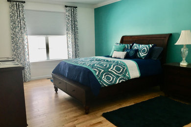 Mid-sized transitional master laminate floor and beige floor bedroom photo in Other with blue walls