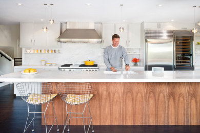 Kitchen - 1960s galley kitchen idea in San Francisco with an undermount sink, flat-panel cabinets, white cabinets, white backsplash, stainless steel appliances, marble countertops and marble backsplash