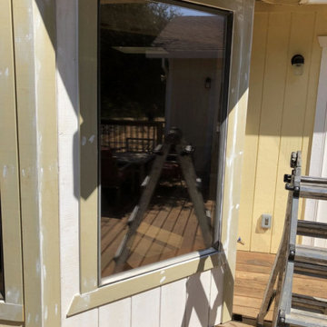 Wood damage at the T1-11 siding and trim, and existing window