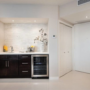 Photo of a modern home bar in Miami with a submerged sink, shaker cabinets, dark wood cabinets, engineered stone countertops, multi-coloured splashback, stone tiled splashback and porcelain flooring.