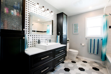 This is an example of a large modern master bathroom in Other with raised-panel cabinets, black cabinets, an alcove tub, a shower/bathtub combo, a two-piece toilet, black and white tile, mosaic tile, grey walls, ceramic floors, a trough sink, laminate benchtops, multi-coloured floor, a shower curtain and white benchtops.