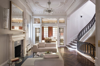 Family room - large victorian open concept dark wood floor and brown floor family room idea in New York with white walls, a standard fireplace and a stone fireplace