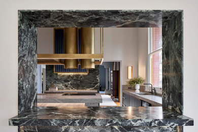Large eclectic kitchen in Adelaide with louvered cabinets, marble benchtops, green splashback, marble splashback, marble floors, with island and grey benchtop.