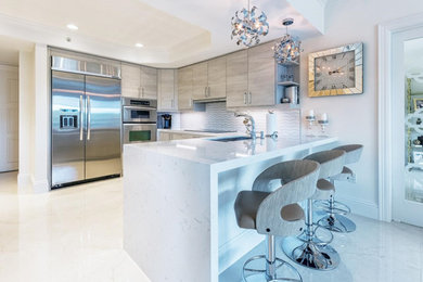Inspiration for a mid-sized modern u-shaped separate kitchen in Miami with a double-bowl sink, flat-panel cabinets, light wood cabinets, quartzite benchtops, multi-coloured splashback, mosaic tile splashback, stainless steel appliances, porcelain floors, a peninsula and beige floor.