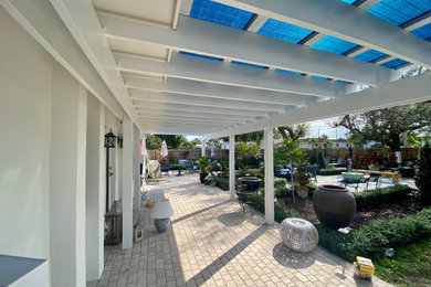 Patio - large patio idea in Miami with a pergola