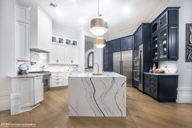 Large transitional kitchen photo in Orlando with recessed-panel cabinets, quartz countertops, an island and white countertops
