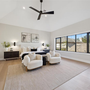 Serene primary suite with vaulted ceiling and sitting area