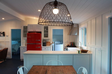 Example of a mid-sized mountain style l-shaped eat-in kitchen design in Santa Barbara with a drop-in sink, recessed-panel cabinets, white cabinets, stainless steel appliances and no island