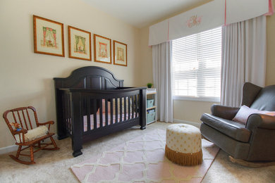 Inspiration for a small timeless girl carpeted nursery remodel in Charlotte with beige walls