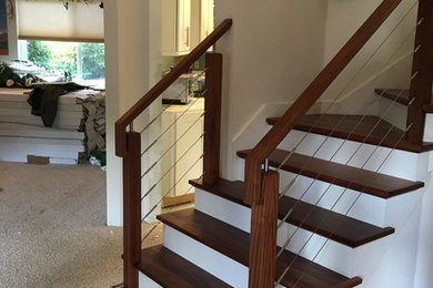 Design ideas for a mid-sized contemporary wood l-shaped staircase in Seattle with painted wood risers and mixed railing.