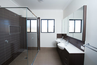Inspiration for a large modern master bathroom in Brisbane with brown cabinets, a double shower, brown tile, subway tile, grey walls, brown floor, a hinged shower door and white benchtops.