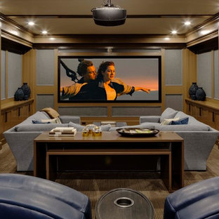 Elegant enclosed carpeted and brown floor home theater photo in Boston with multicolored walls and a projector screen