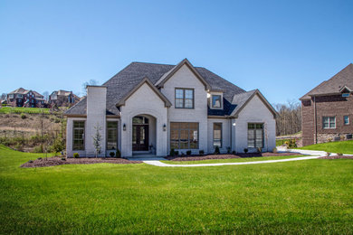 Large transitional white two-story house exterior idea with a shingle roof