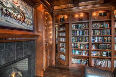 Arts and crafts home office in Other with dark hardwood floors, a standard fireplace and a tile fireplace surround.