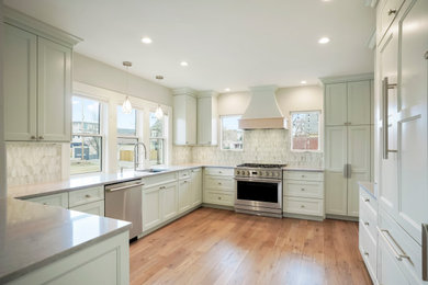 Example of a mid-sized transitional eat-in kitchen design in Denver with an undermount sink, shaker cabinets, white cabinets, paneled appliances and a peninsula