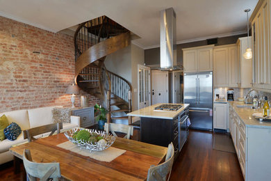 Example of a mid-sized classic l-shaped dark wood floor open concept kitchen design in New Orleans with an undermount sink, stainless steel appliances, an island, shaker cabinets, white cabinets, marble countertops, metallic backsplash and metal backsplash