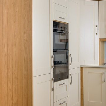 An exiting traditional kitchen with cream Shaker doors and light wood trimmings